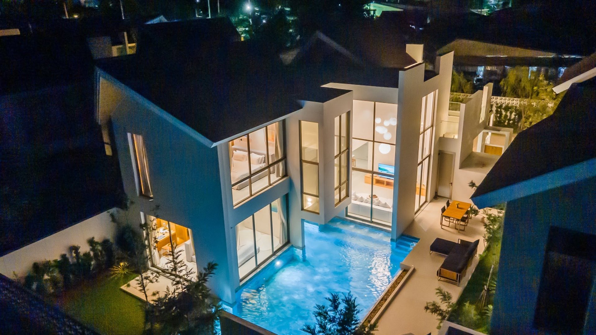 Night aerial view of the illuminated villa and pool