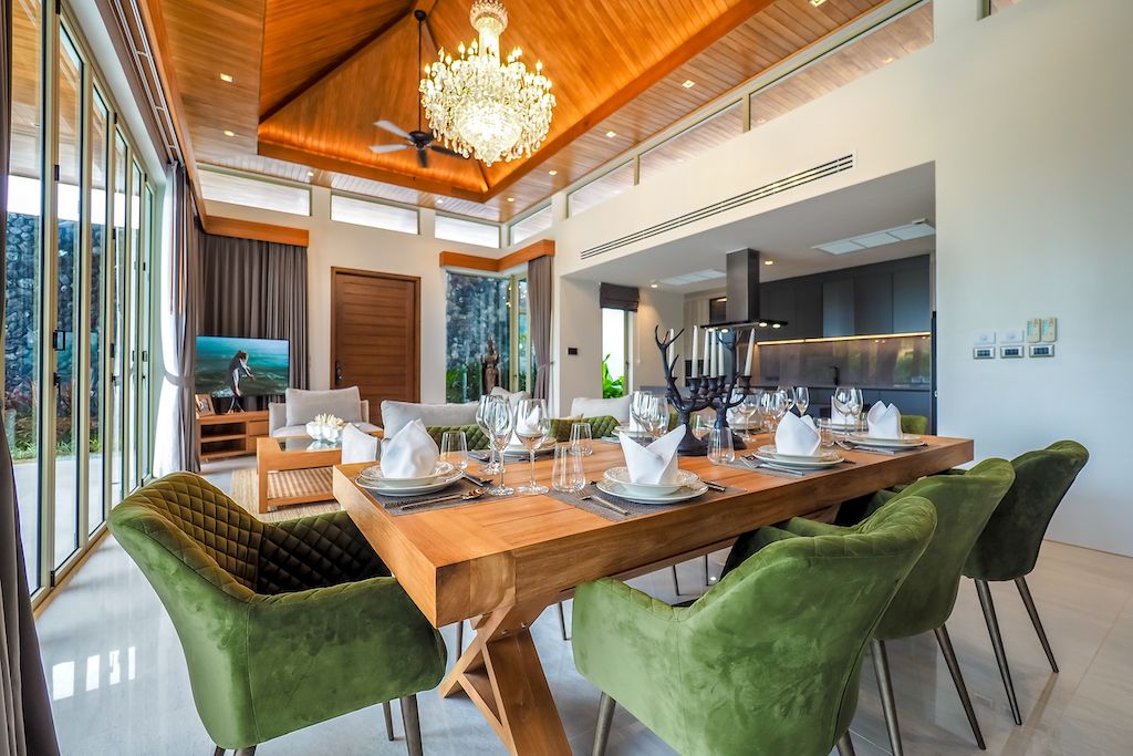 Dining table set for ten beneath a crystal chandelier