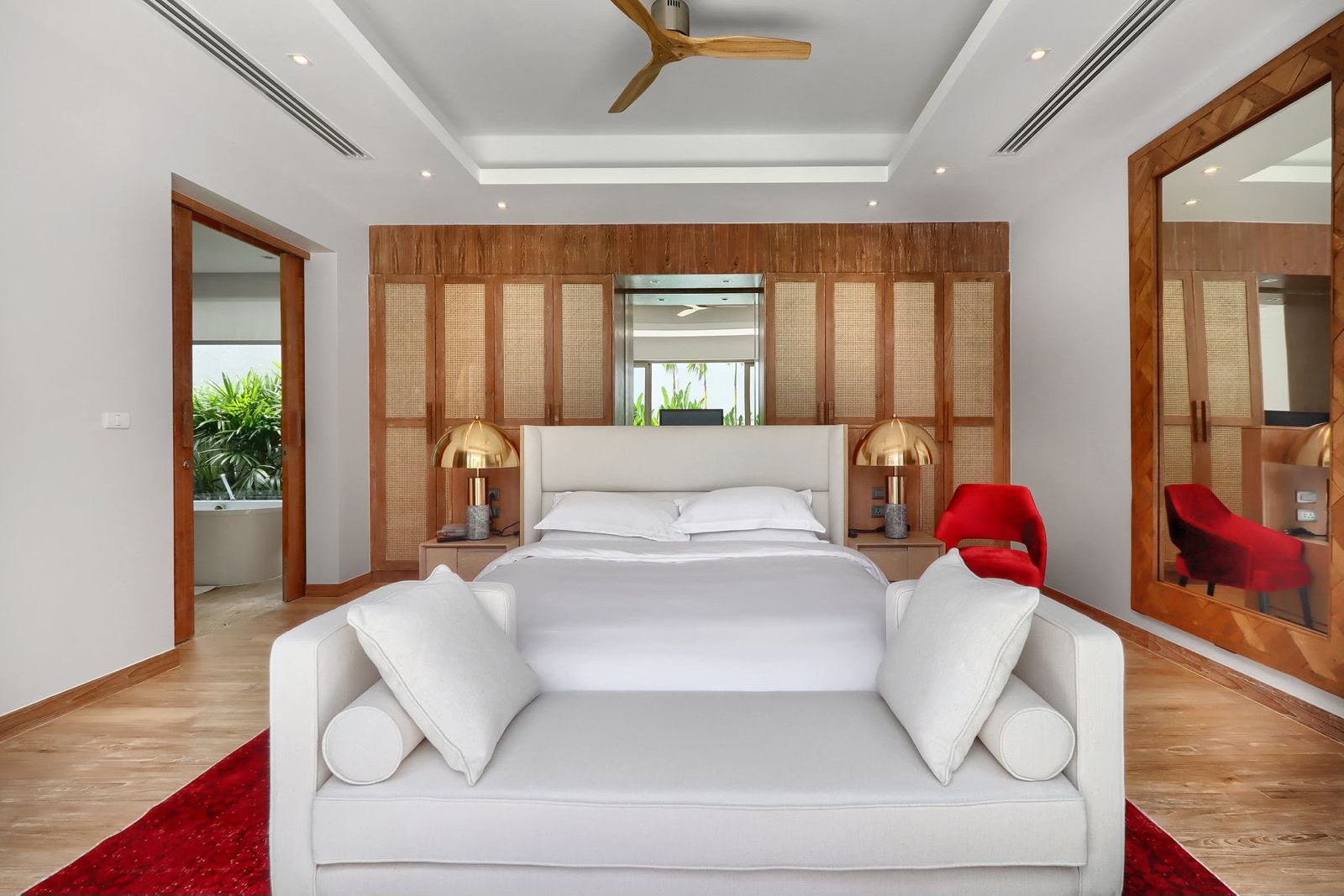 Master suite with cane wardrobe panelling, daybed and statement mirror