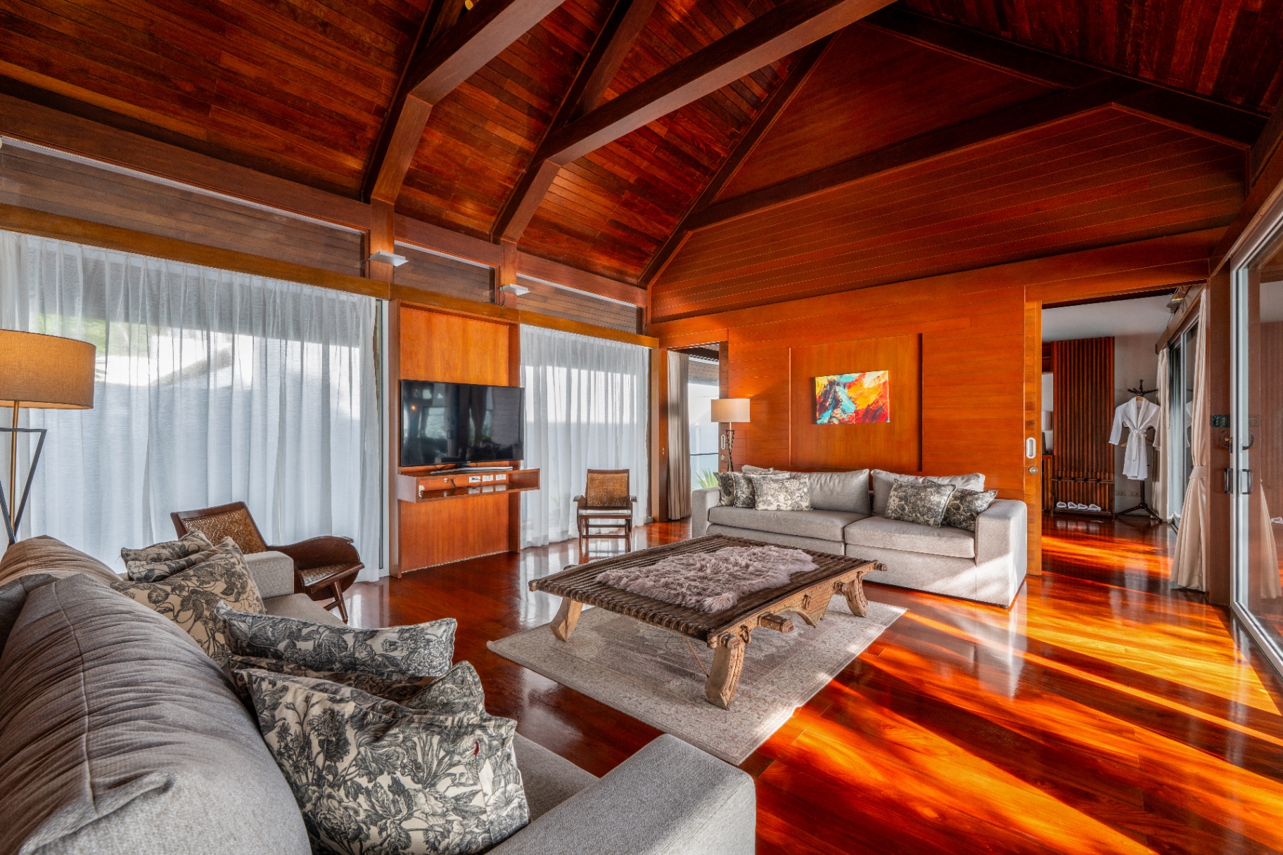 Spacious teak living lounge opening to the terrace