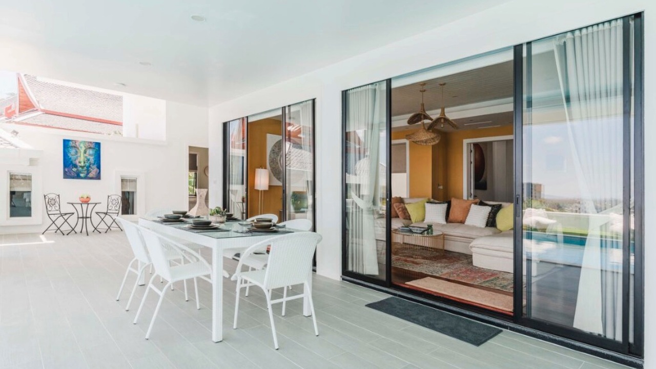 Covered outdoor dining terrace with sliding doors to the living room