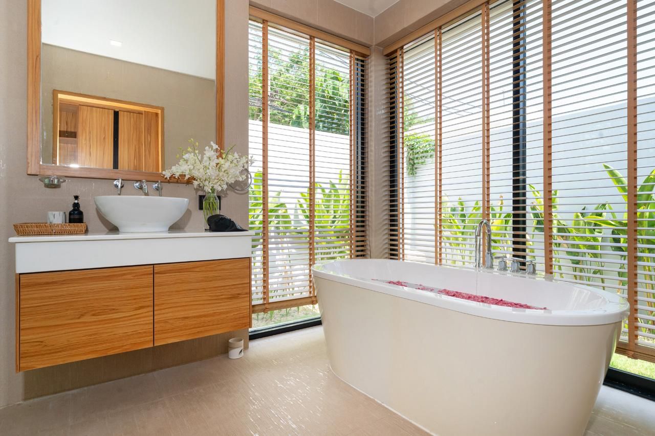 Master bathroom with soaking tub and timber blinds