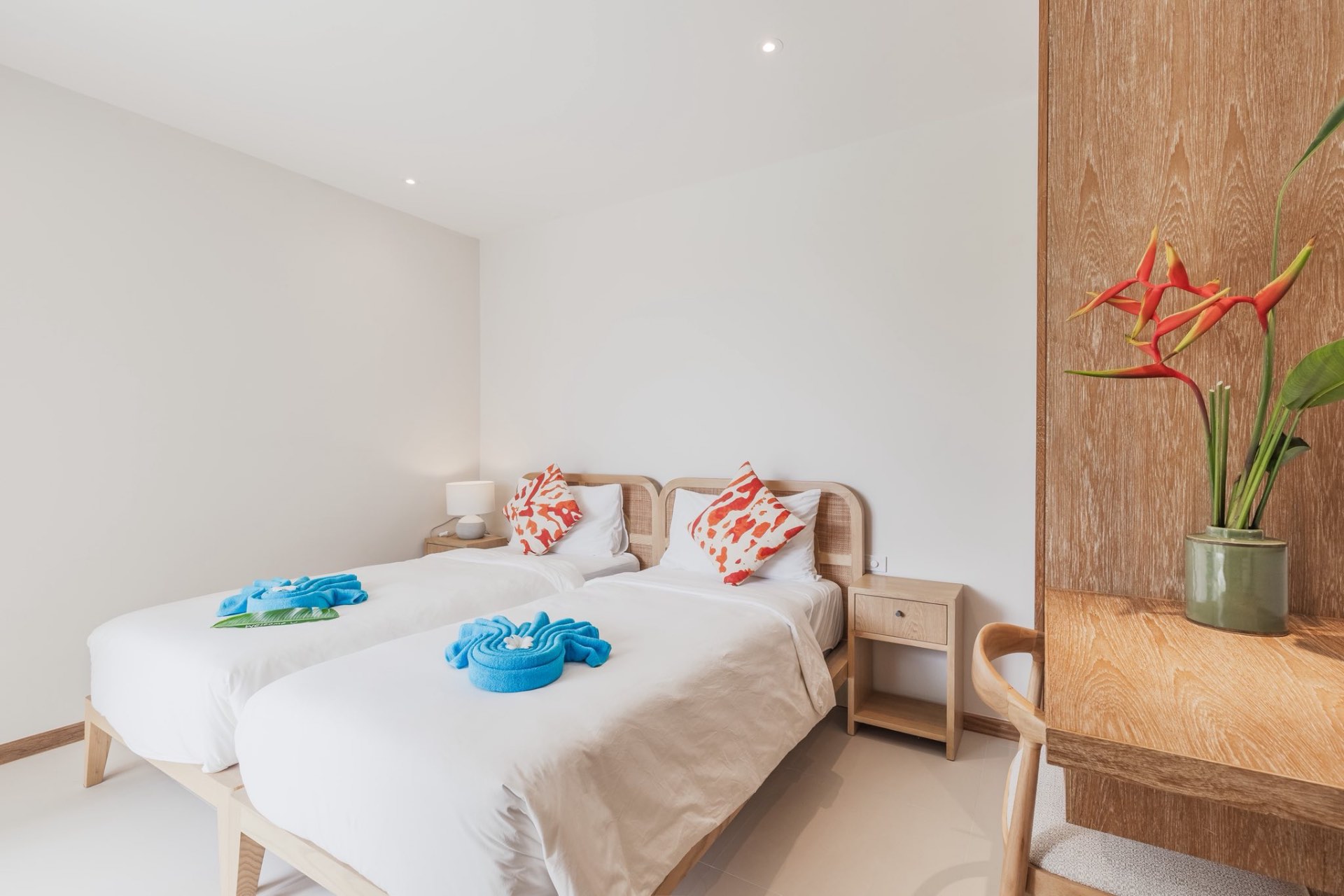 Twin bedroom with rattan headboards and tropical accents