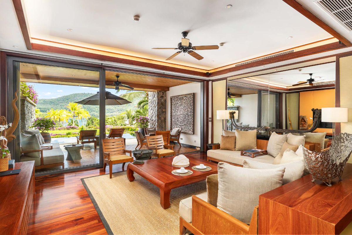 Living room opening to pool deck and tropical garden