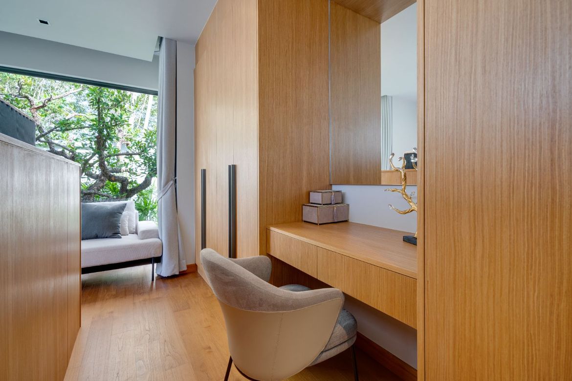 Master dressing area with built-in vanity and wardrobes