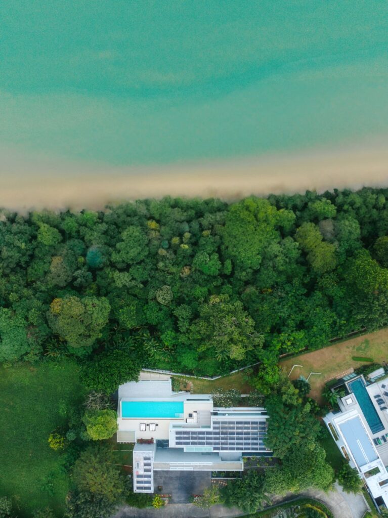 Aerial view of designer villa surrounded by tropical forest