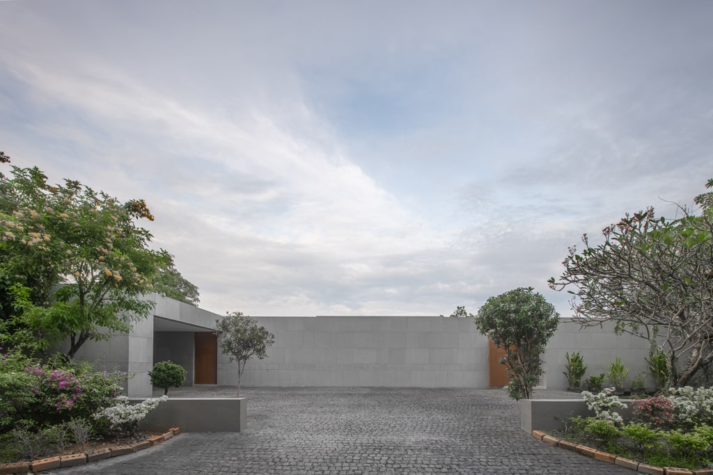 Cobblestone entrance courtyard with teak doors