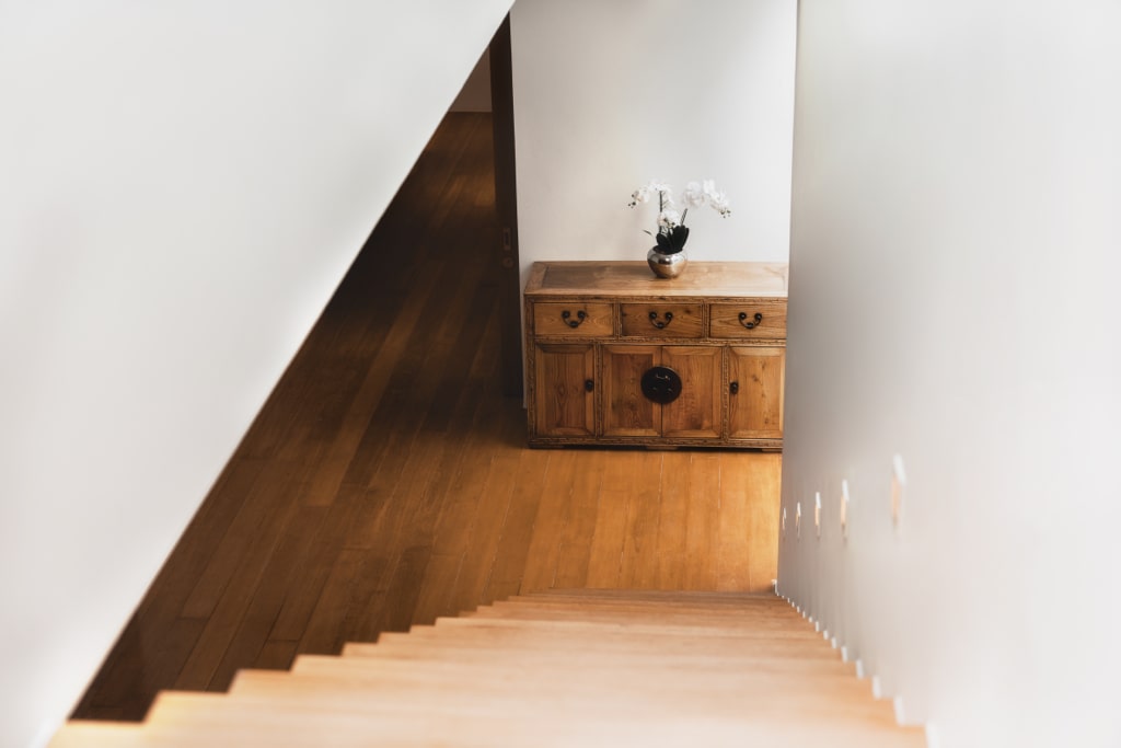 Minimalist staircase with teak wood and orchid