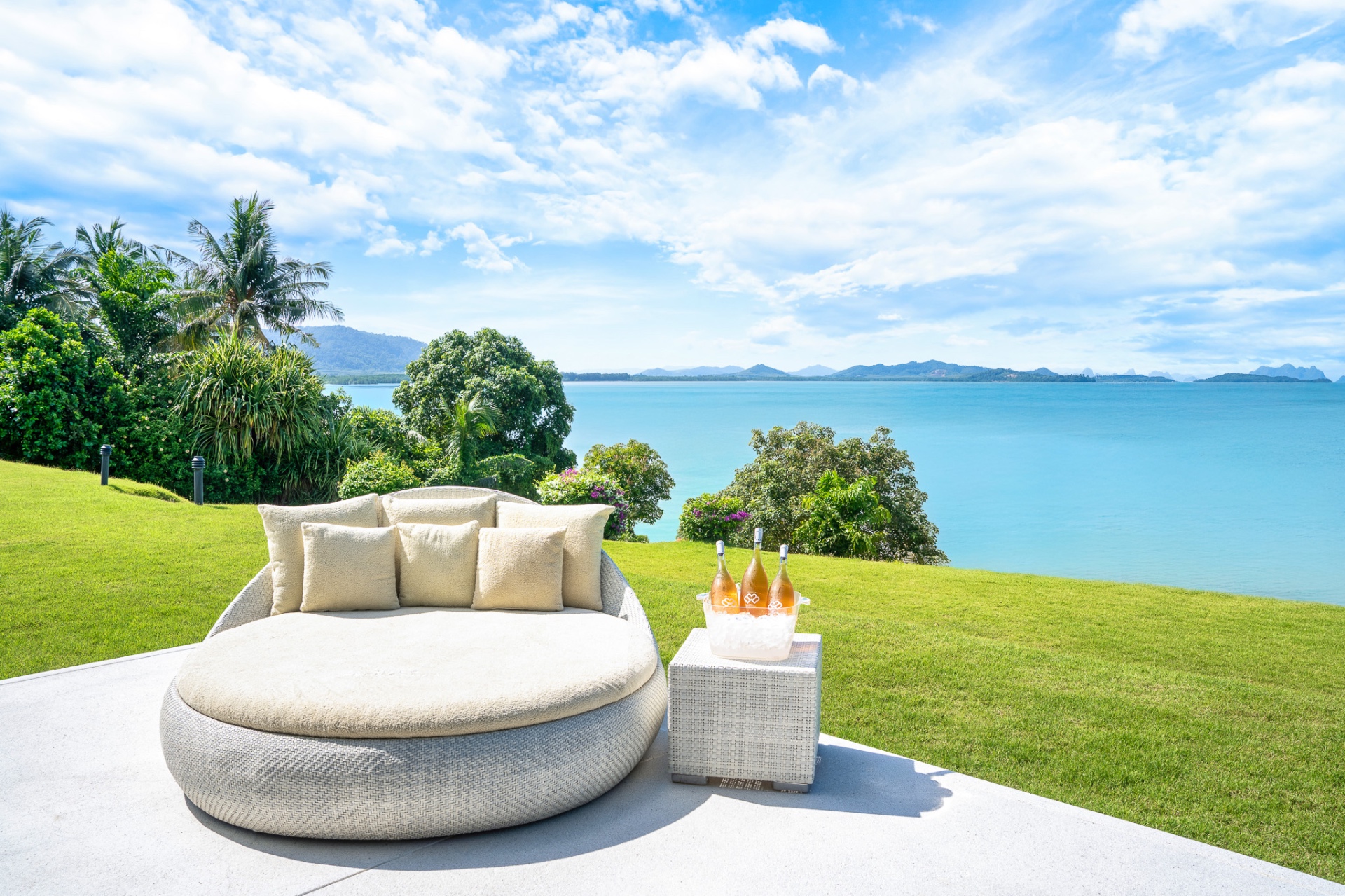 Daybed on lawn with champagne and ocean views