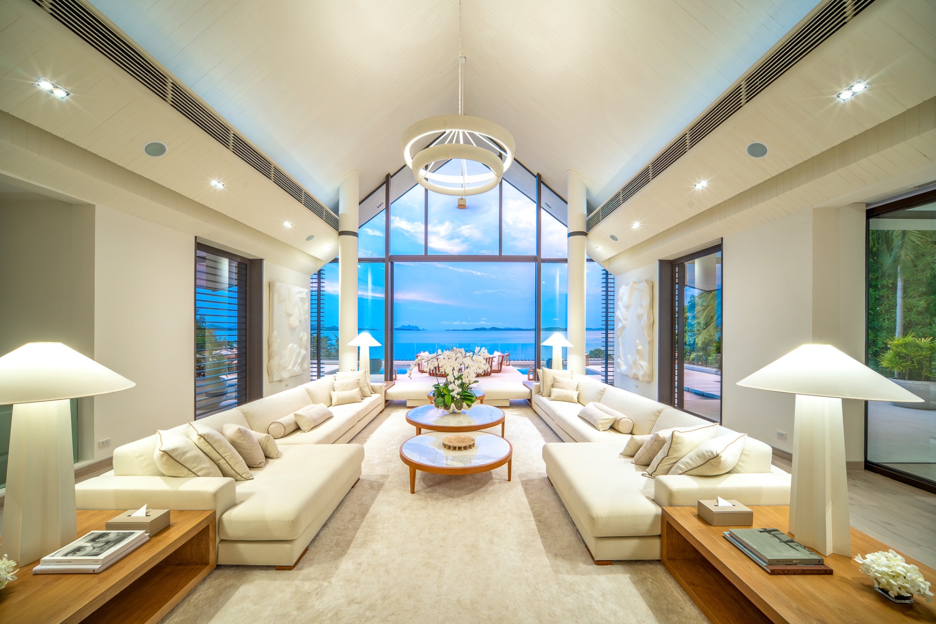 Living room at twilight with dramatic ocean panorama