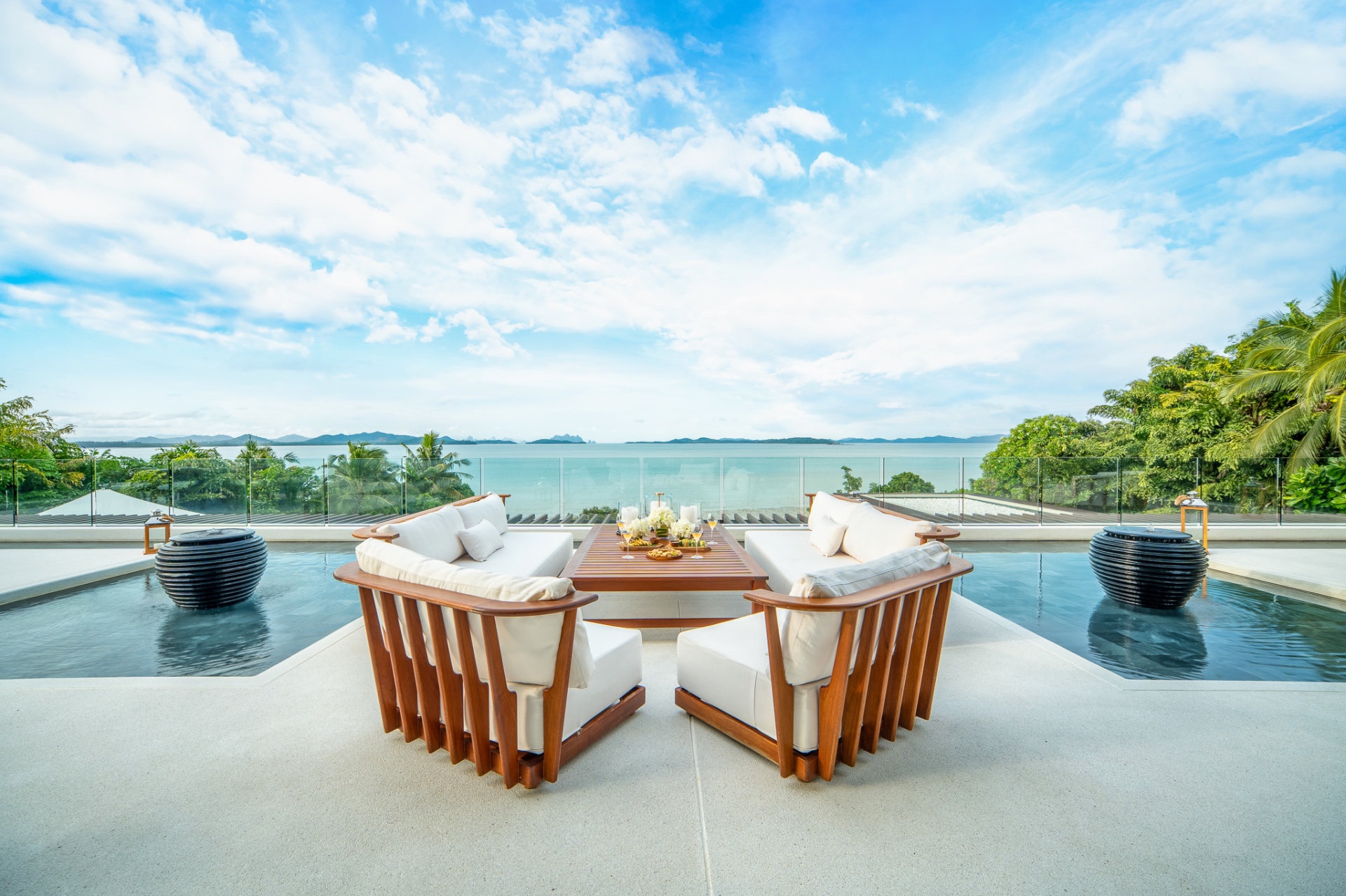 Poolside lounge seating with sea views