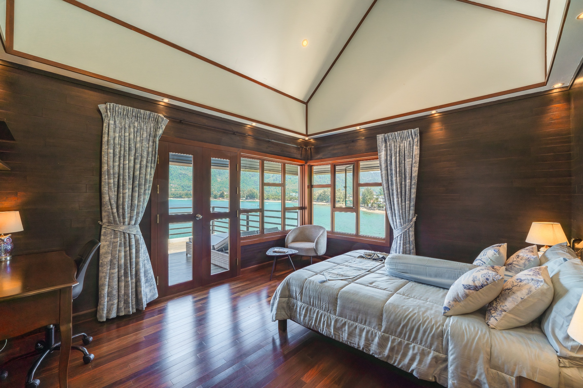 Bedroom with balcony doors and ocean panorama