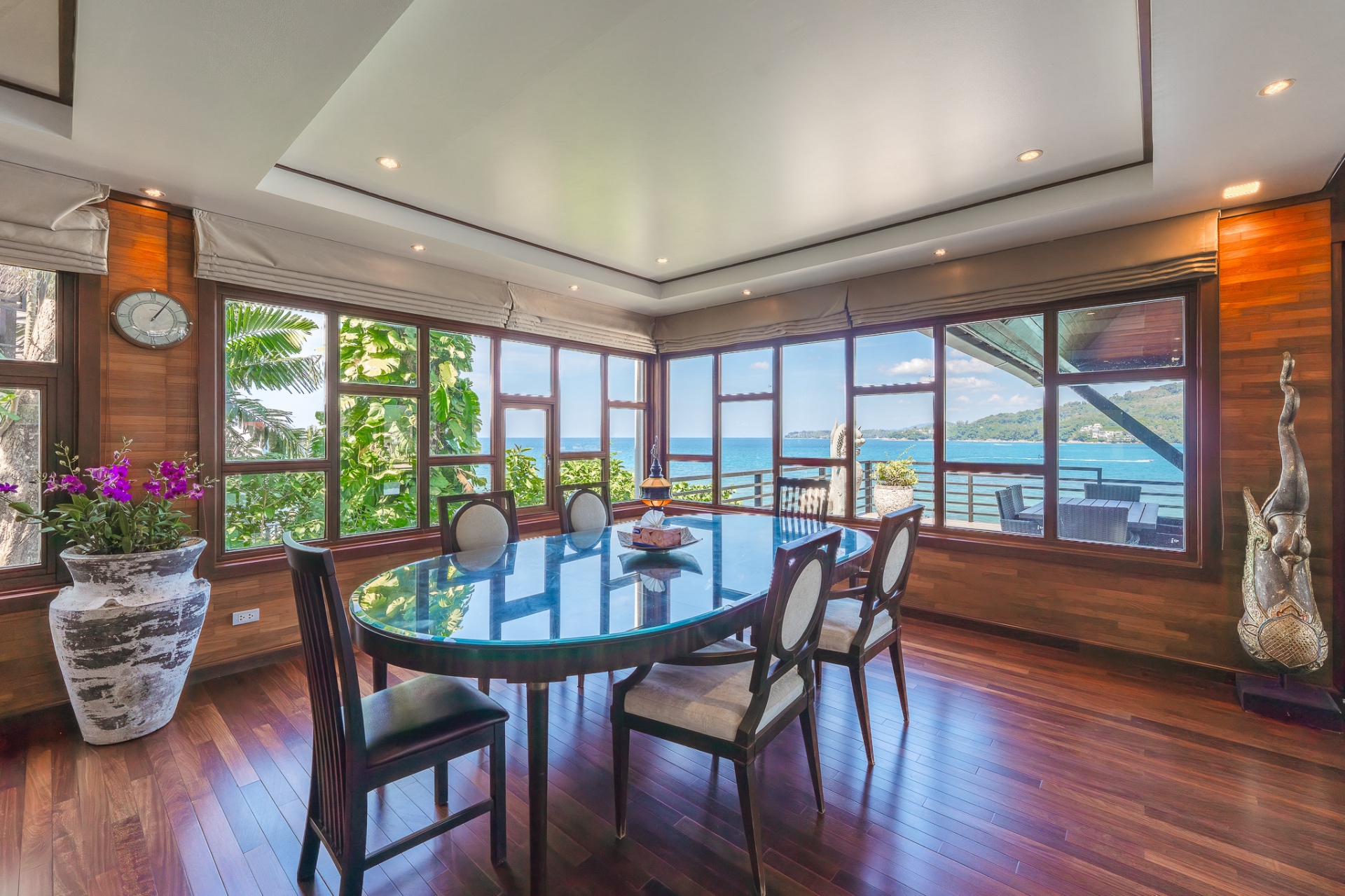 Formal dining room with teak walls and sea views