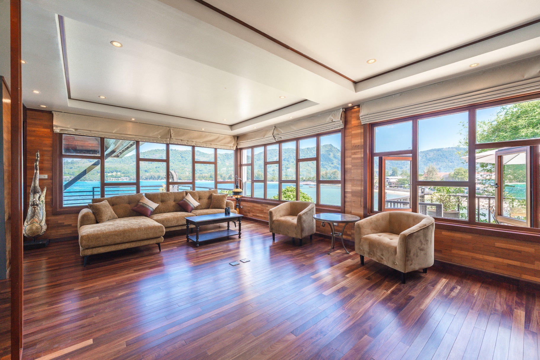 Living room with teak wood floors and ocean panorama