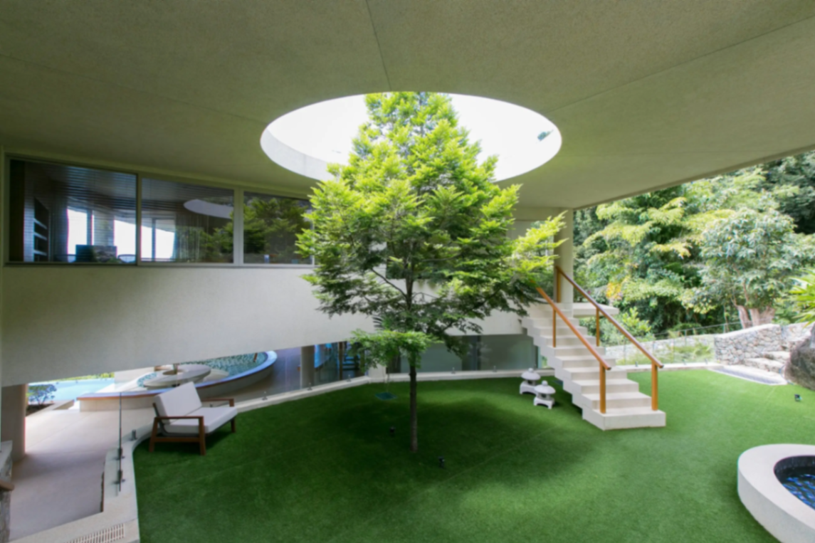 Landscaped courtyard with dramatic skylight oculus