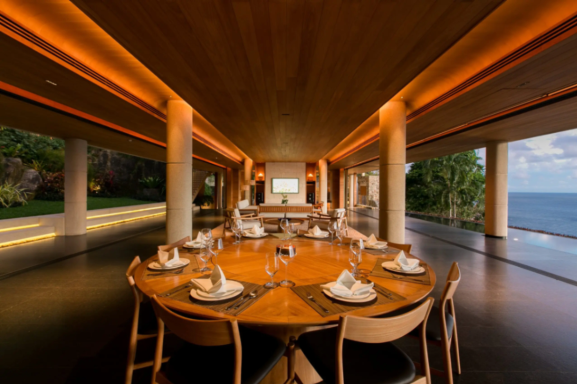 Round dining setup in open pavilion at sunset