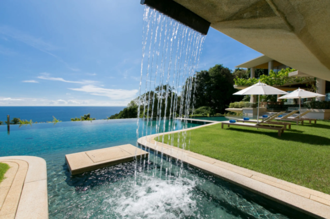 Infinity pool waterfall detail with panoramic ocean backdrop