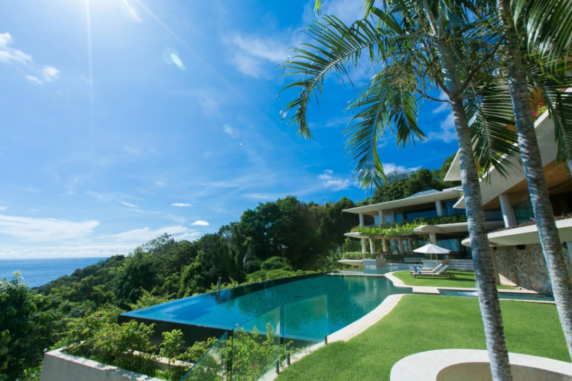 Pool terrace with palm trees and ocean views