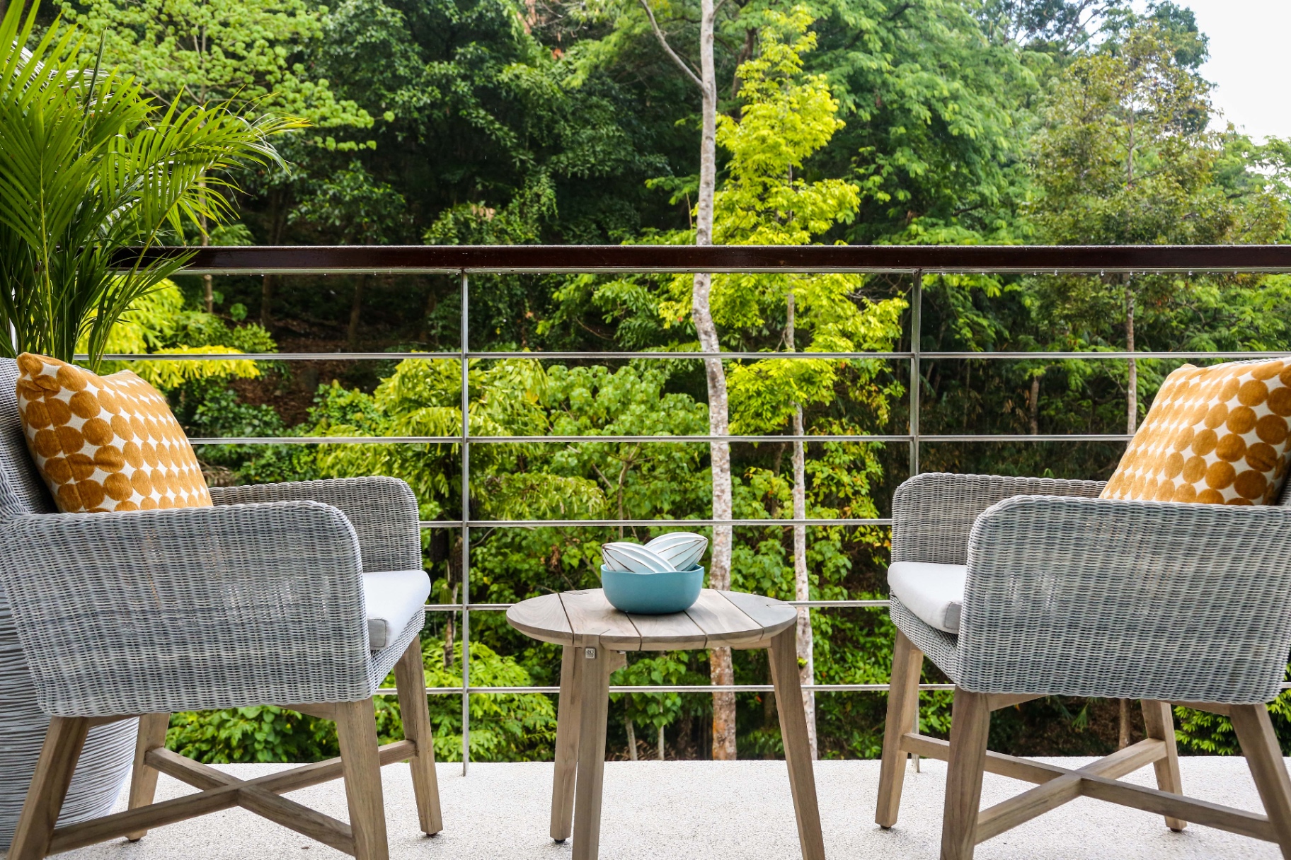 Private terrace with wicker chairs and jungle view
