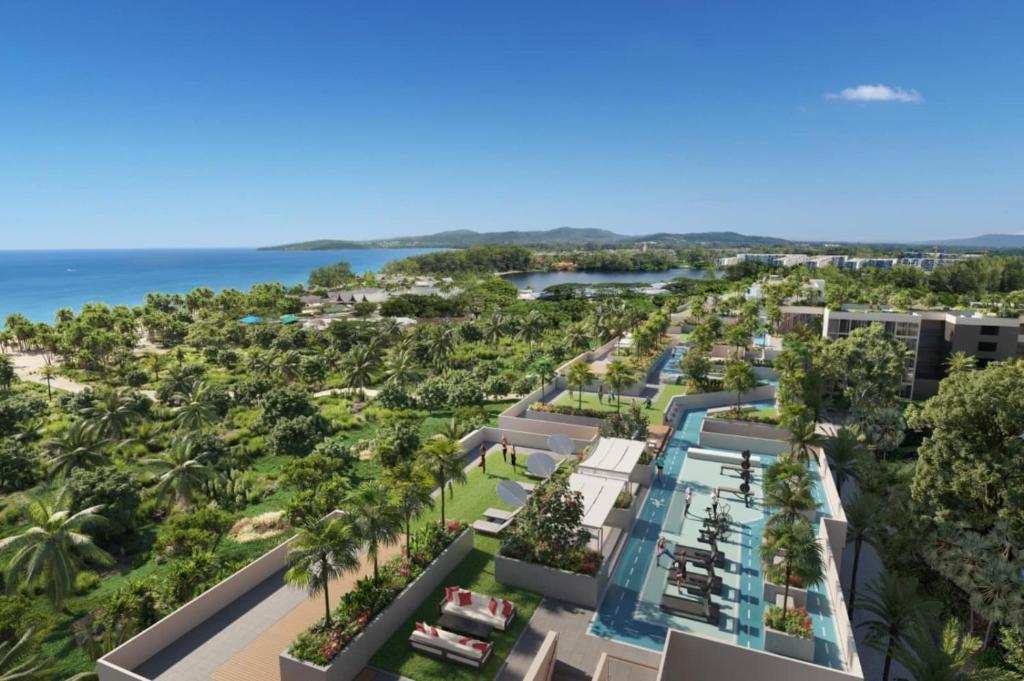 Aerial view of development with rooftop pools and beach
