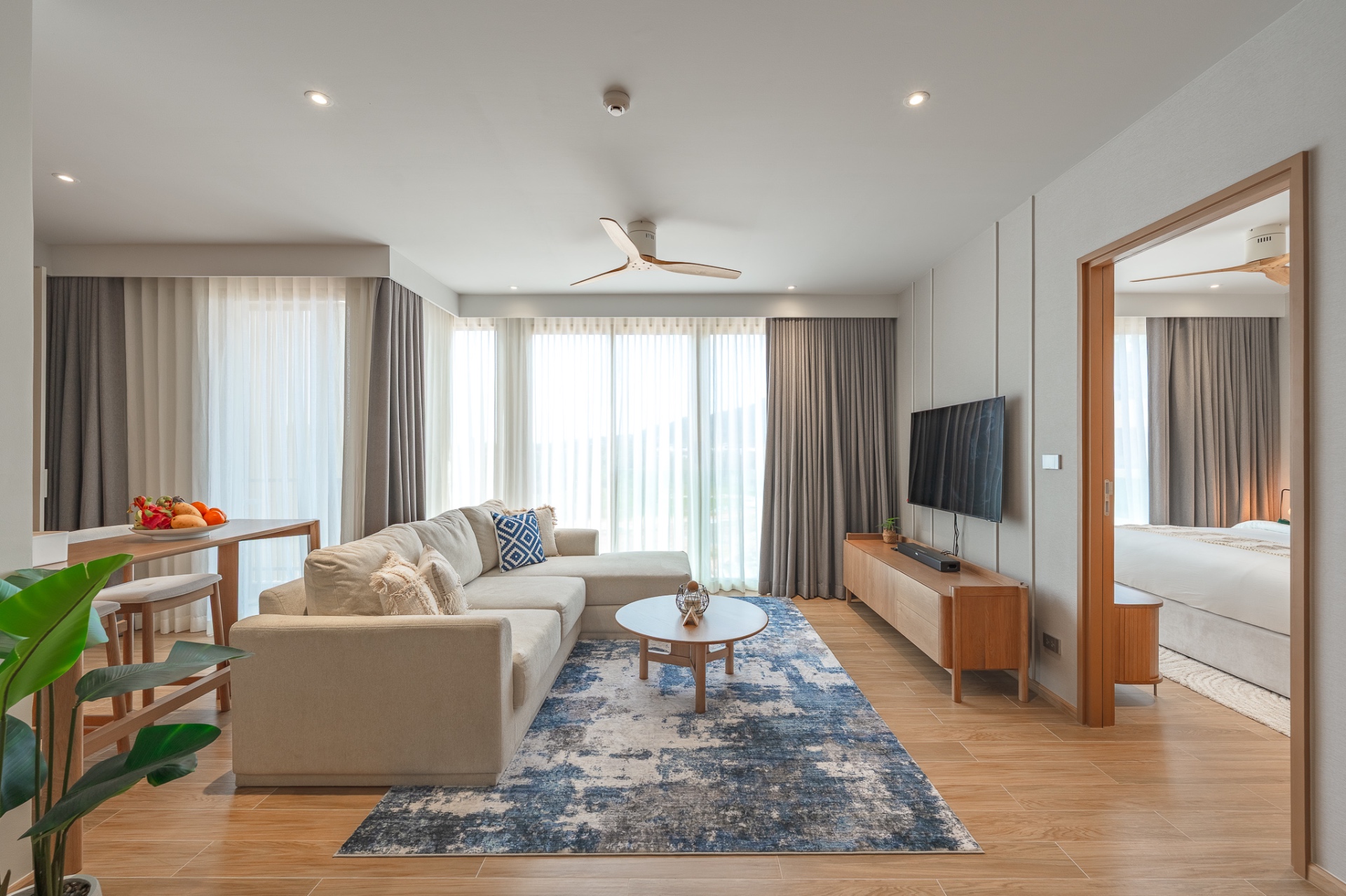 Living area with view into bedroom suite