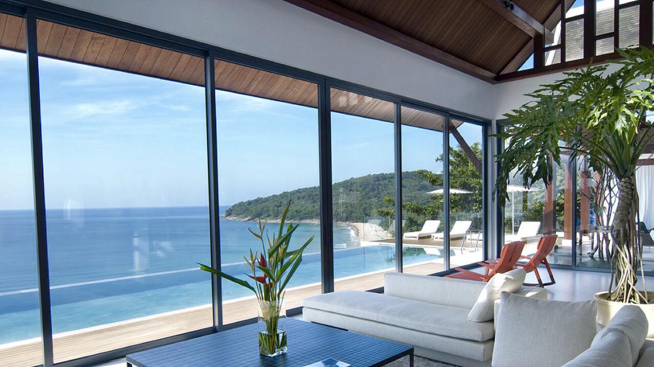 Living room with floor-to-ceiling windows and pool view