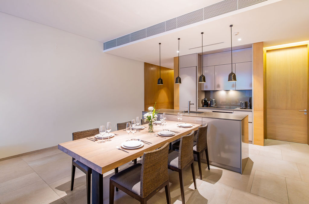 Dining area with pendant lights and modern kitchen