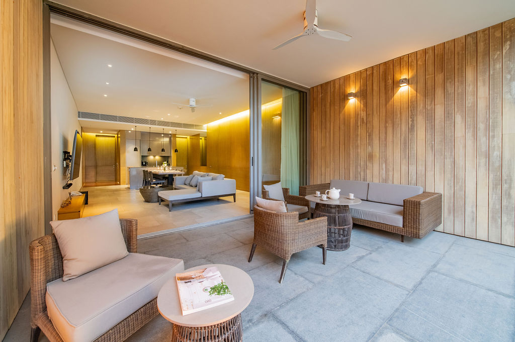 Indoor-outdoor living area with evening lighting