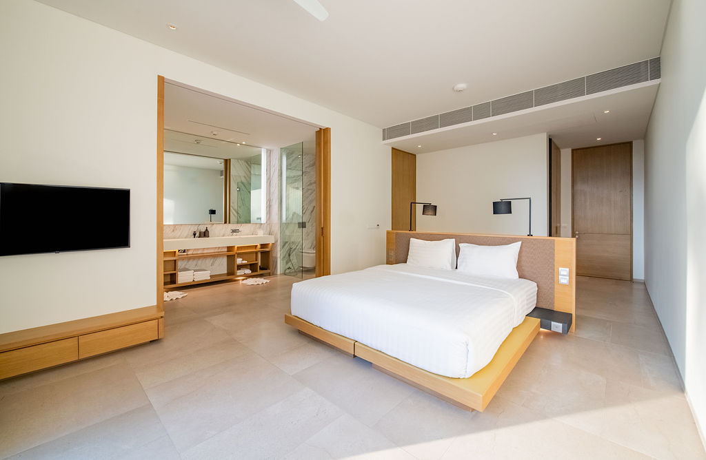 Master suite with wall-mounted TV and marble bathroom