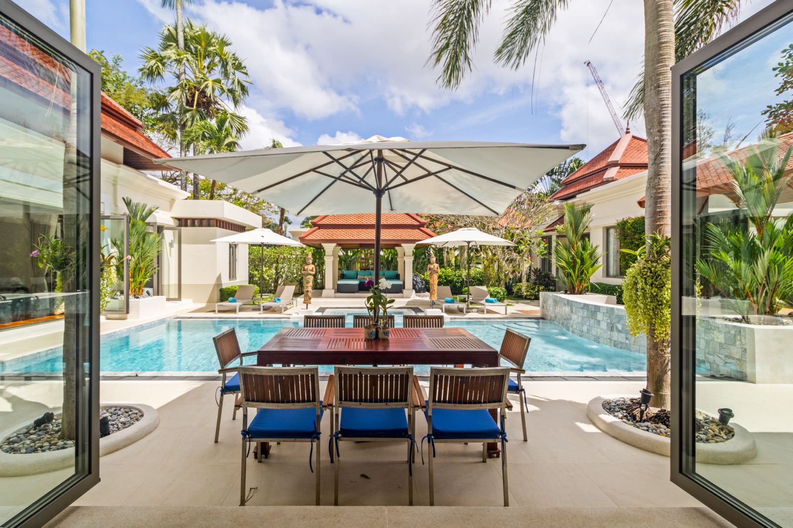 Outdoor dining area with pool view