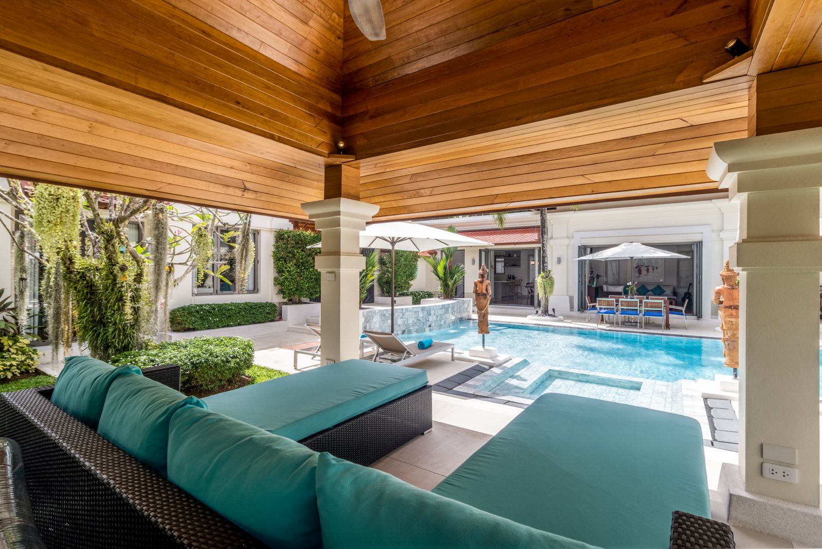 Covered sala lounge overlooking pool and garden
