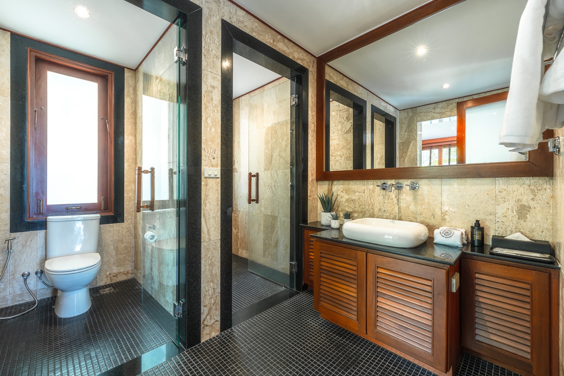 Ensuite bathroom with mosaic tiles and glass shower