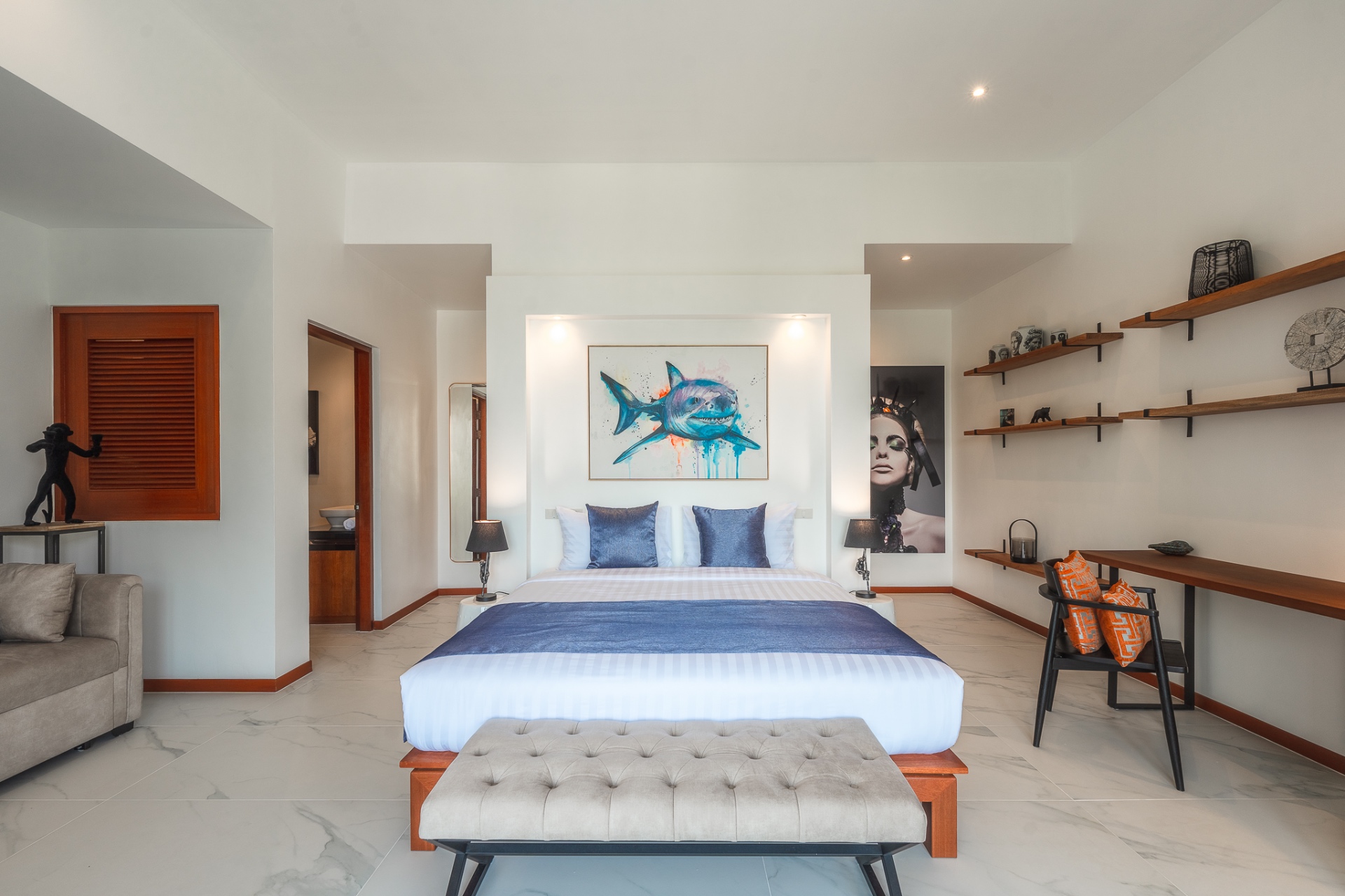 Spacious bedroom with shark artwork and designer furnishings