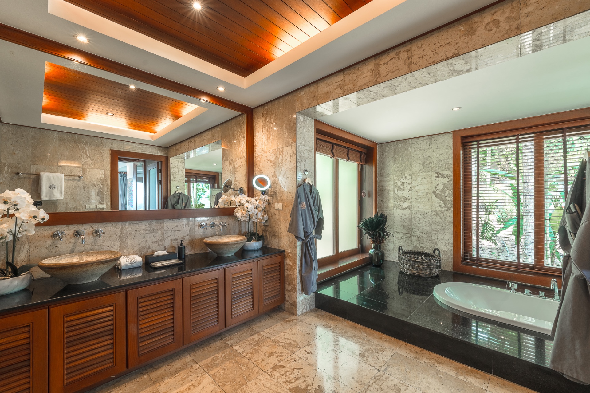 Master bathroom with double vanity, soaking tub and teak ceiling