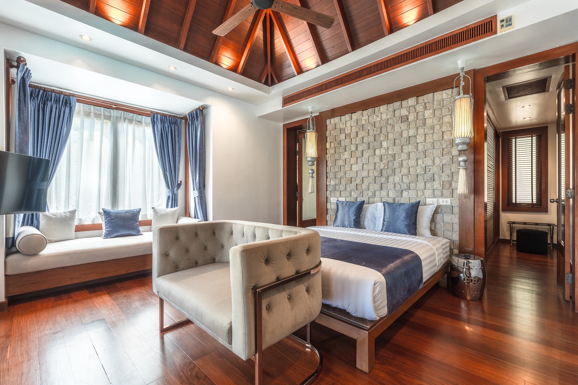 Suite with stone headboard, teak ceiling and window seat