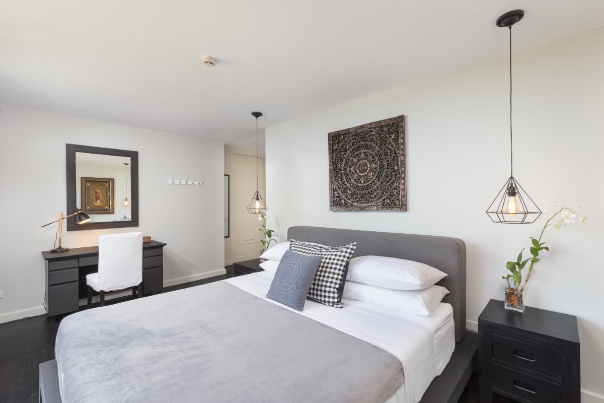 Guest bedroom with Thai art decor and modern lighting