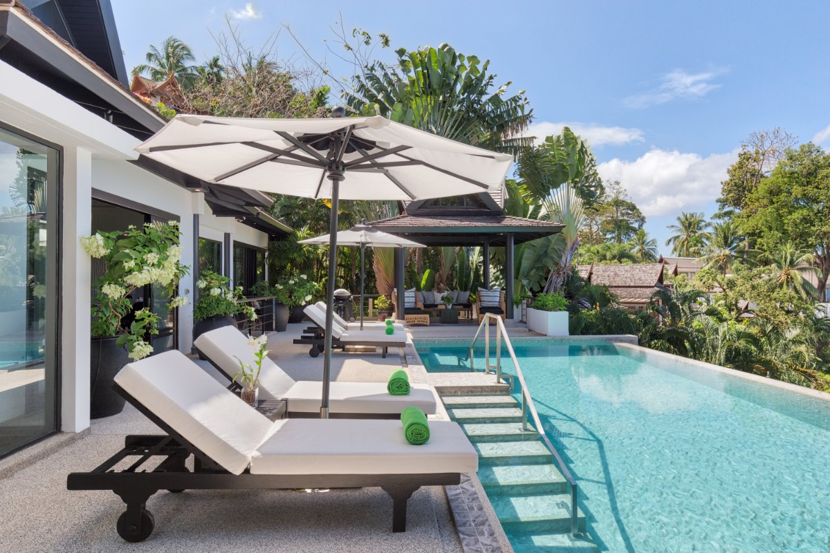 Pool terrace with umbrellas at luxury Thailand villa